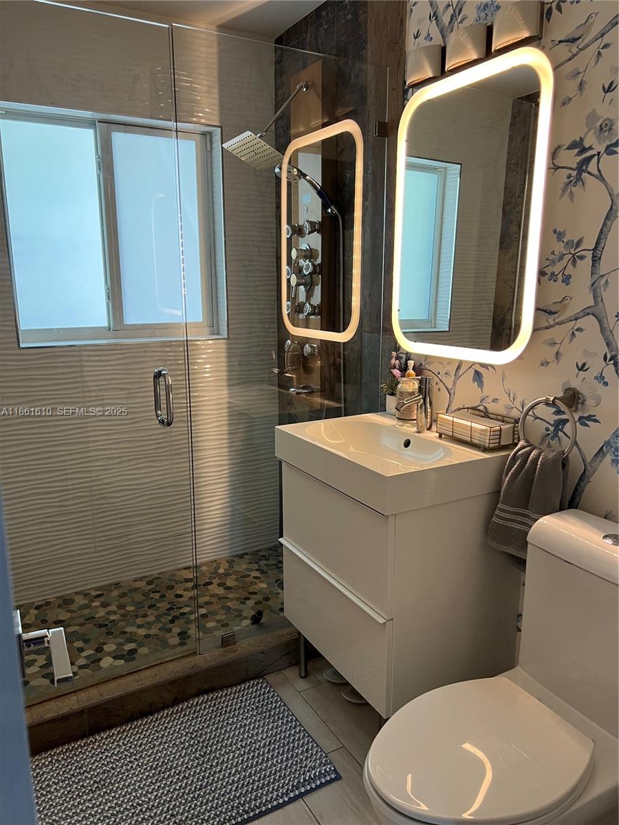 1900 Keystone Boulevard North Miami, FL 33181 - Photo 12 of 14 a bathroom with a toilet sink and shower