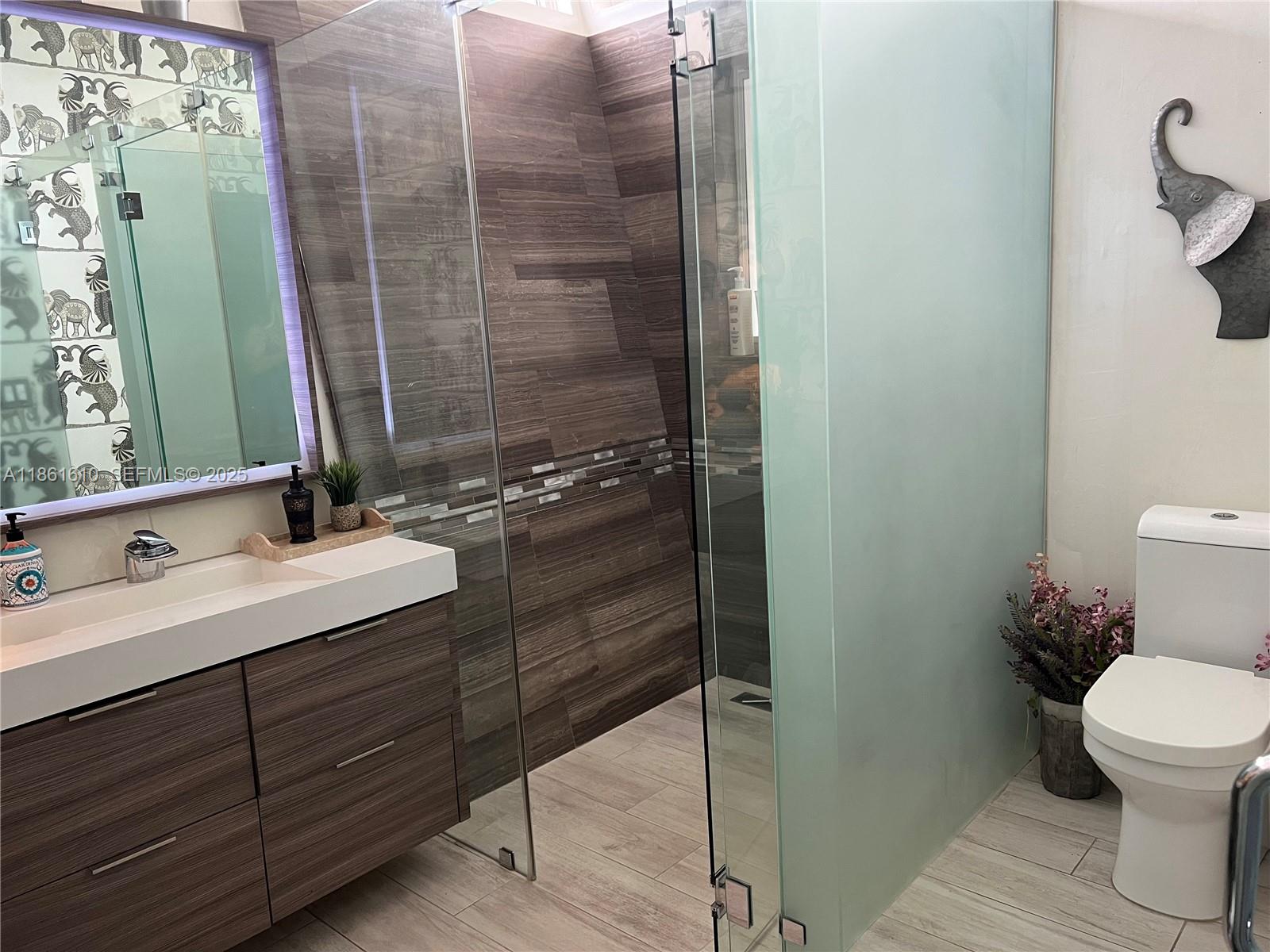 1900 Keystone Boulevard North Miami, FL 33181 - Photo 7 of 14 a bathroom with a granite countertop sink toilet and shower