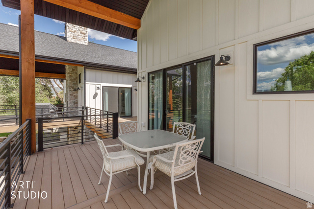 1188 South Old Trappers Loop Road Huntsville, UT 84317 - Photo 71 of 92 Spacious outdoor deck featuring composite decking, black metal railings, and a board and batten exterior