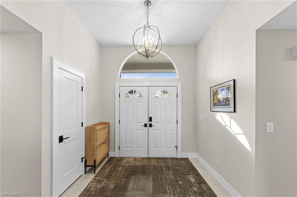 4724 Riverside Drive Estero, FL 33928 - Photo 4 of 44 a view of a hallway with wooden floor and a bathroom