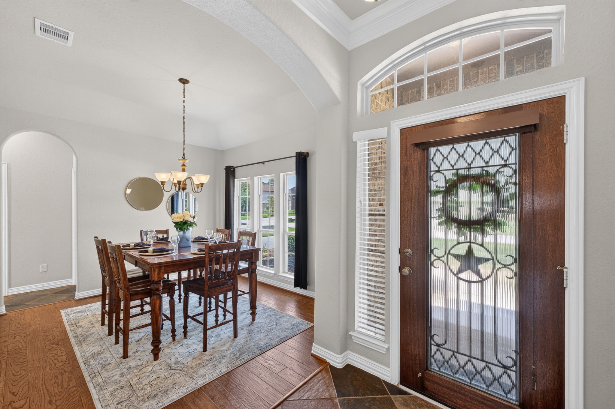 The formal dining room is conveniently positioned near the entry and features hardwood flooring and abundant natural light.