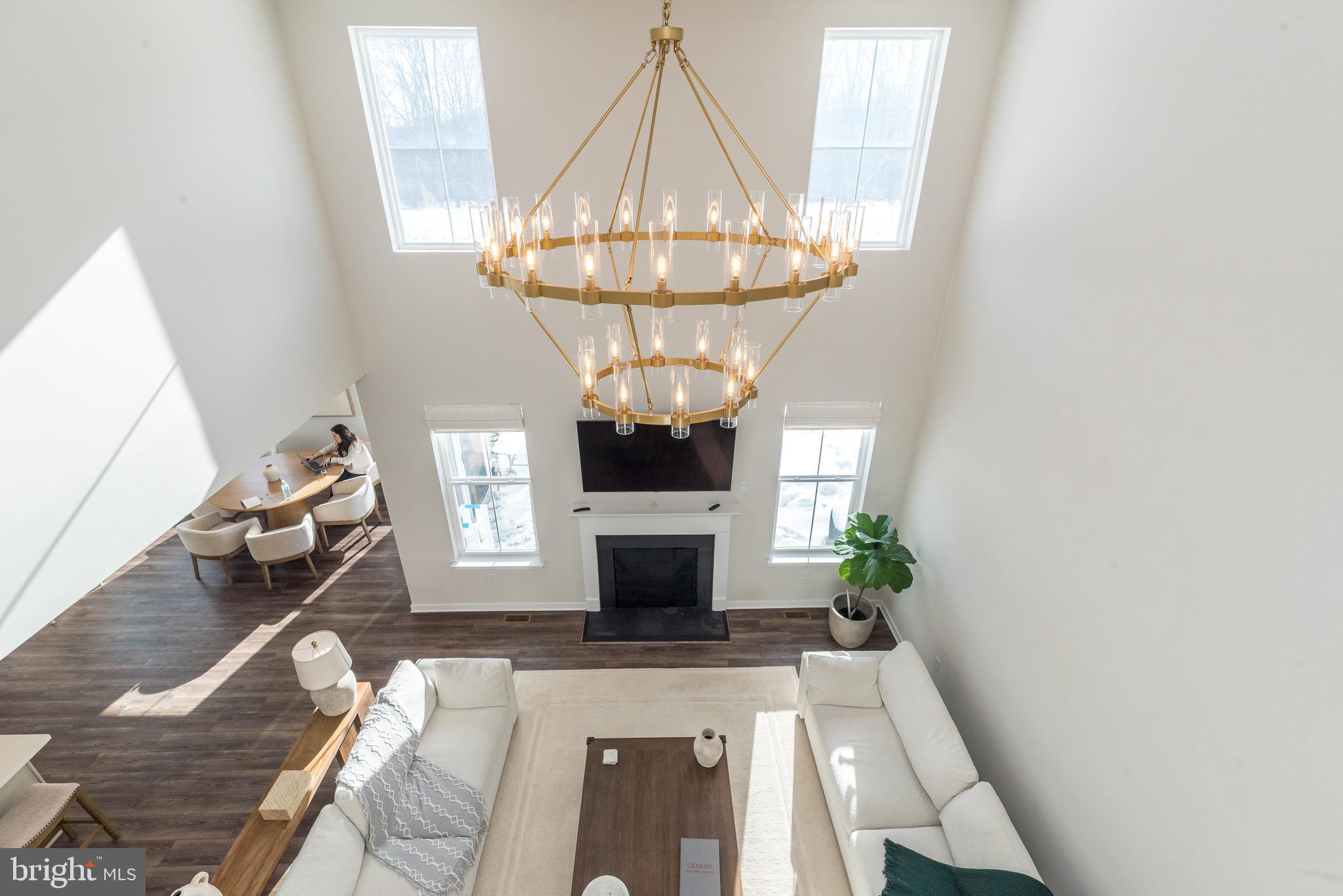 1033 Mariwill Drive Quakertown, PA 18951 - Photo 17 of 67 a living room with furniture a chandelier and a fireplace