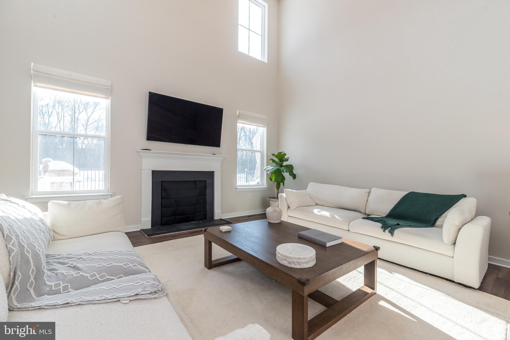 1033 Mariwill Drive Quakertown, PA 18951 - Photo 18 of 67 a living room with furniture a fireplace and a flat screen tv