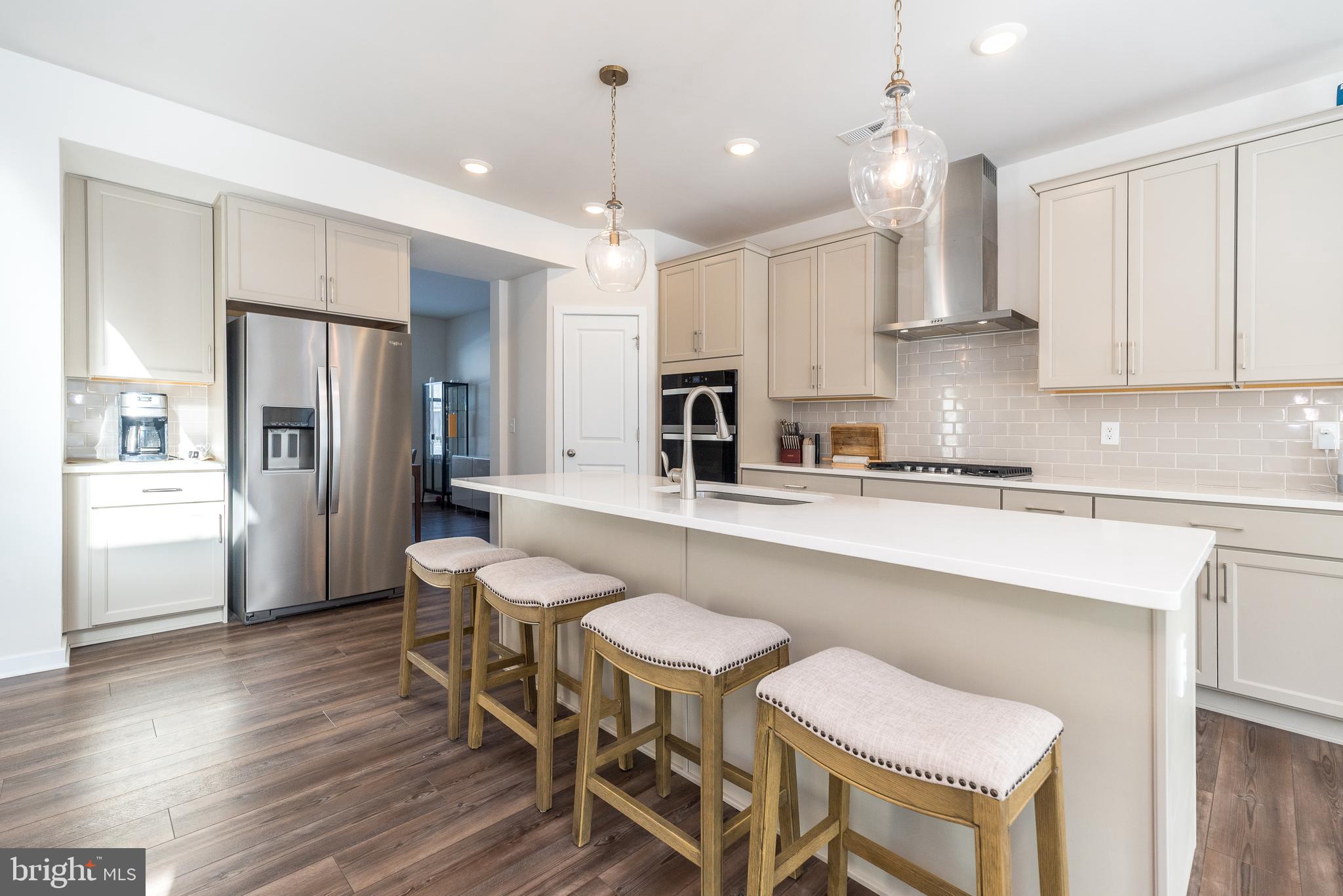 1033 Mariwill Drive Quakertown, PA 18951 - Photo 25 of 67 a kitchen with stainless steel appliances granite countertop a table chairs refrigerator and sink