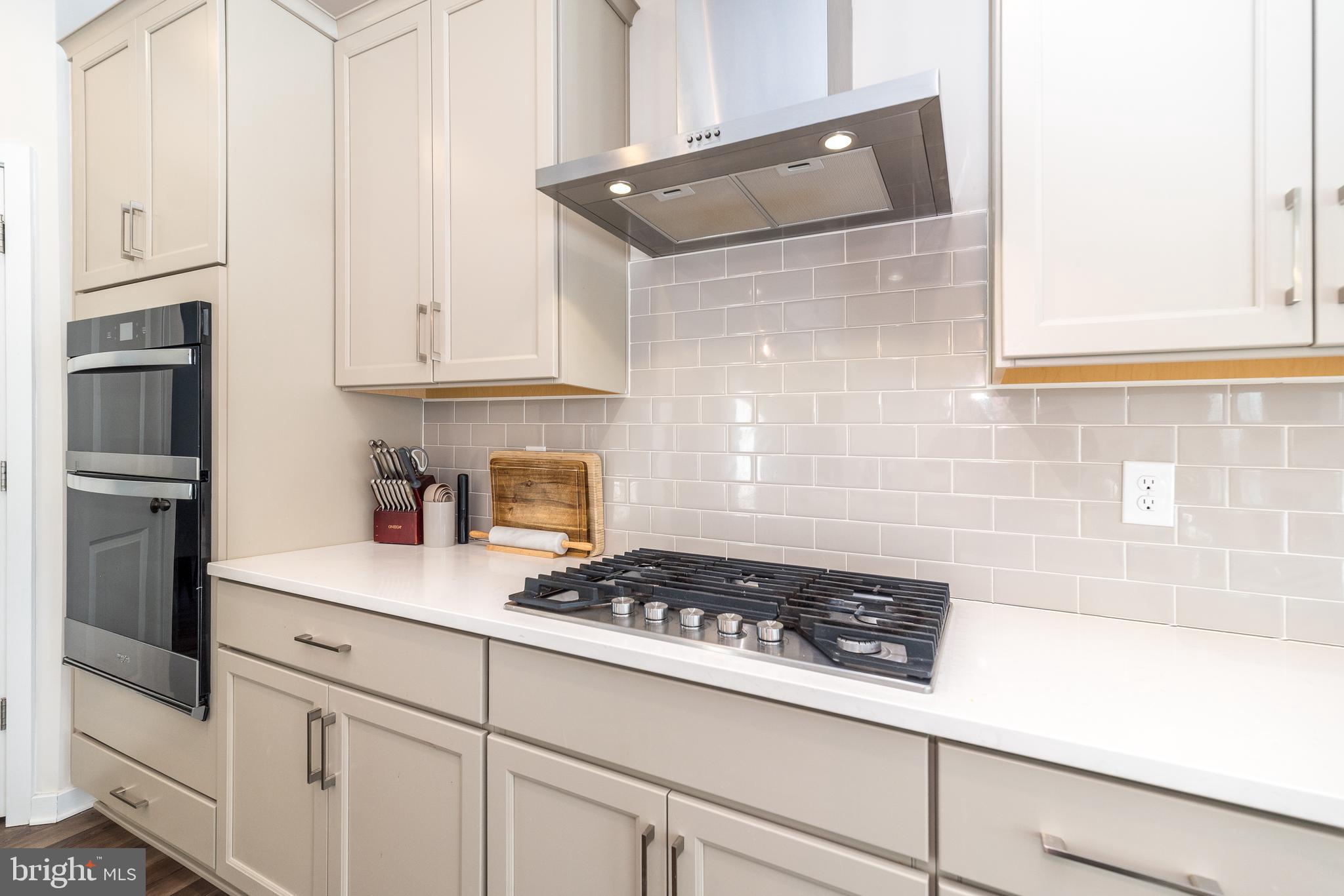 1033 Mariwill Drive Quakertown, PA 18951 - Photo 26 of 67 a kitchen with cabinets and a stove top oven