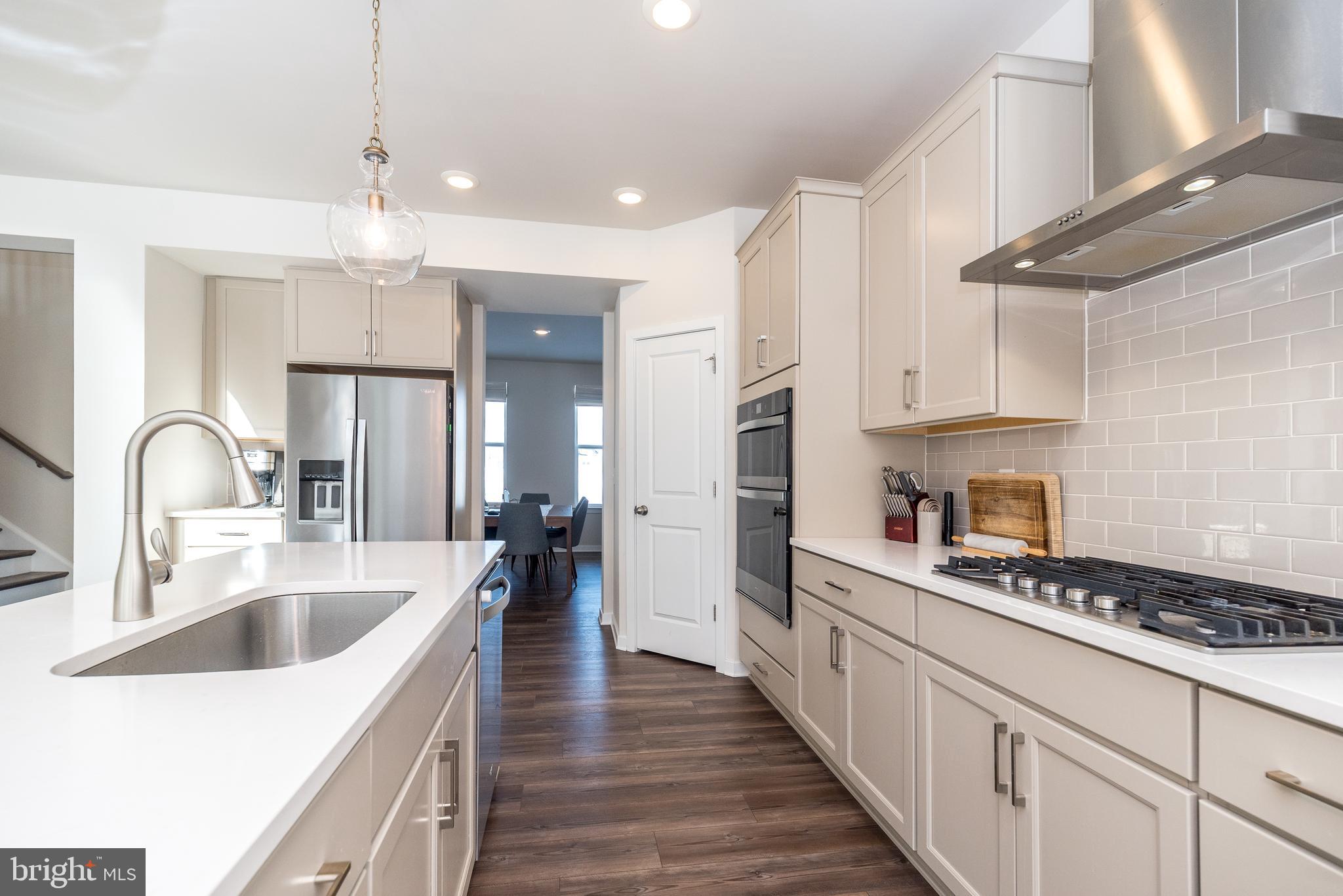 1033 Mariwill Drive Quakertown, PA 18951 - Photo 27 of 67 a kitchen with stainless steel appliances granite countertop a sink and cabinets