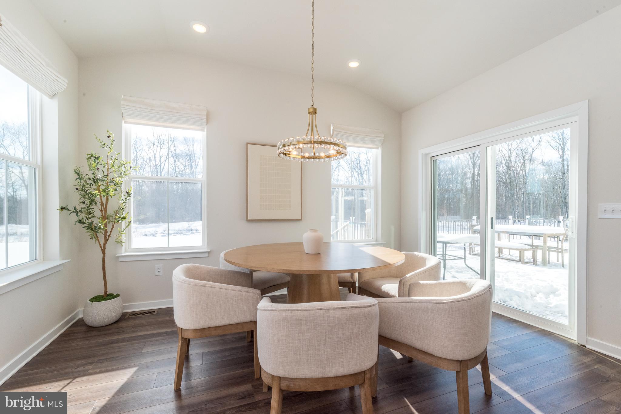 1033 Mariwill Drive Quakertown, PA 18951 - Photo 30 of 67 a dining room with furniture a chandelier and wooden floor