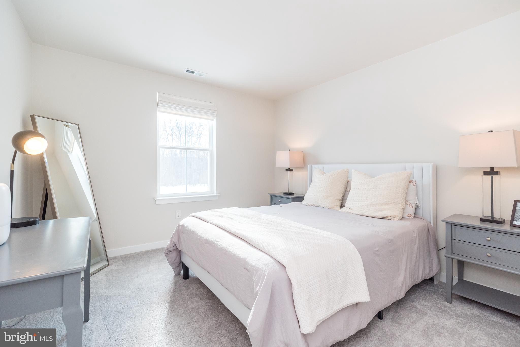 1033 Mariwill Drive Quakertown, PA 18951 - Photo 59 of 67 a bedroom with a bed and a large window