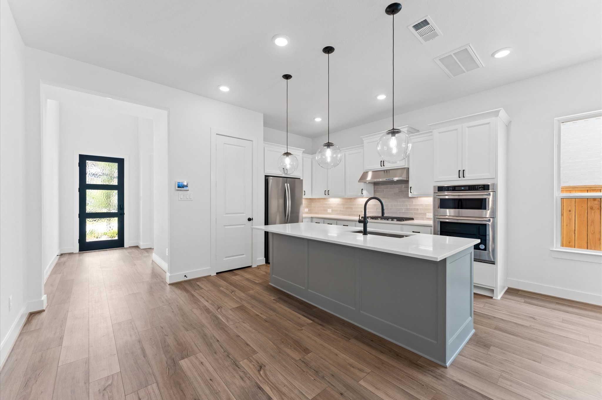 8218 Sherman Pk Trail Spring, TX 77389 - Photo 8 of 28 a large kitchen with kitchen island a sink stainless steel appliances and cabinets