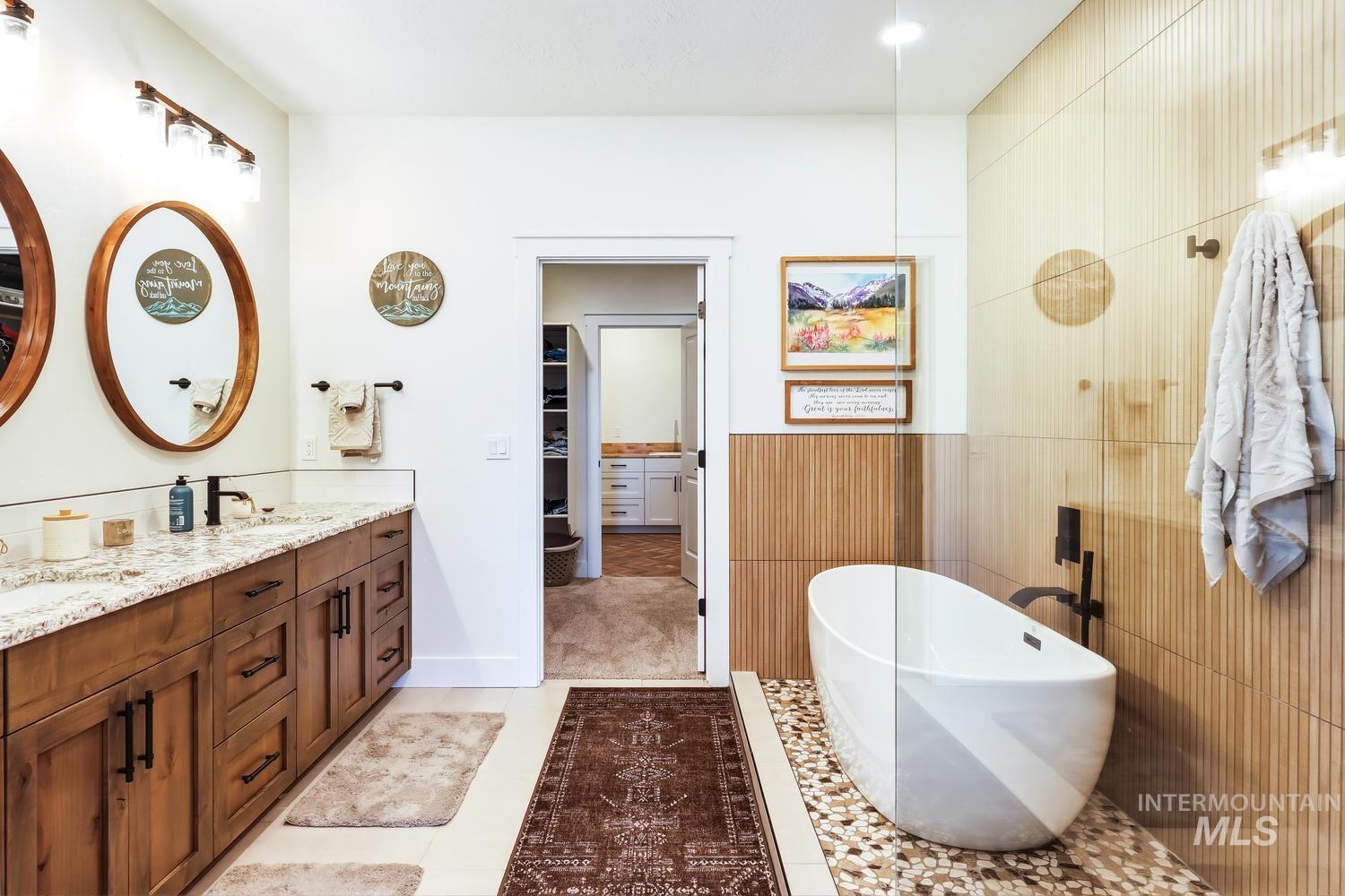18658 Tranquil Place Caldwell, ID 83607 - Photo 23 of 44 Dual vanity with wood-finish cabinetry, light-toned countertops, and matte black fixtures