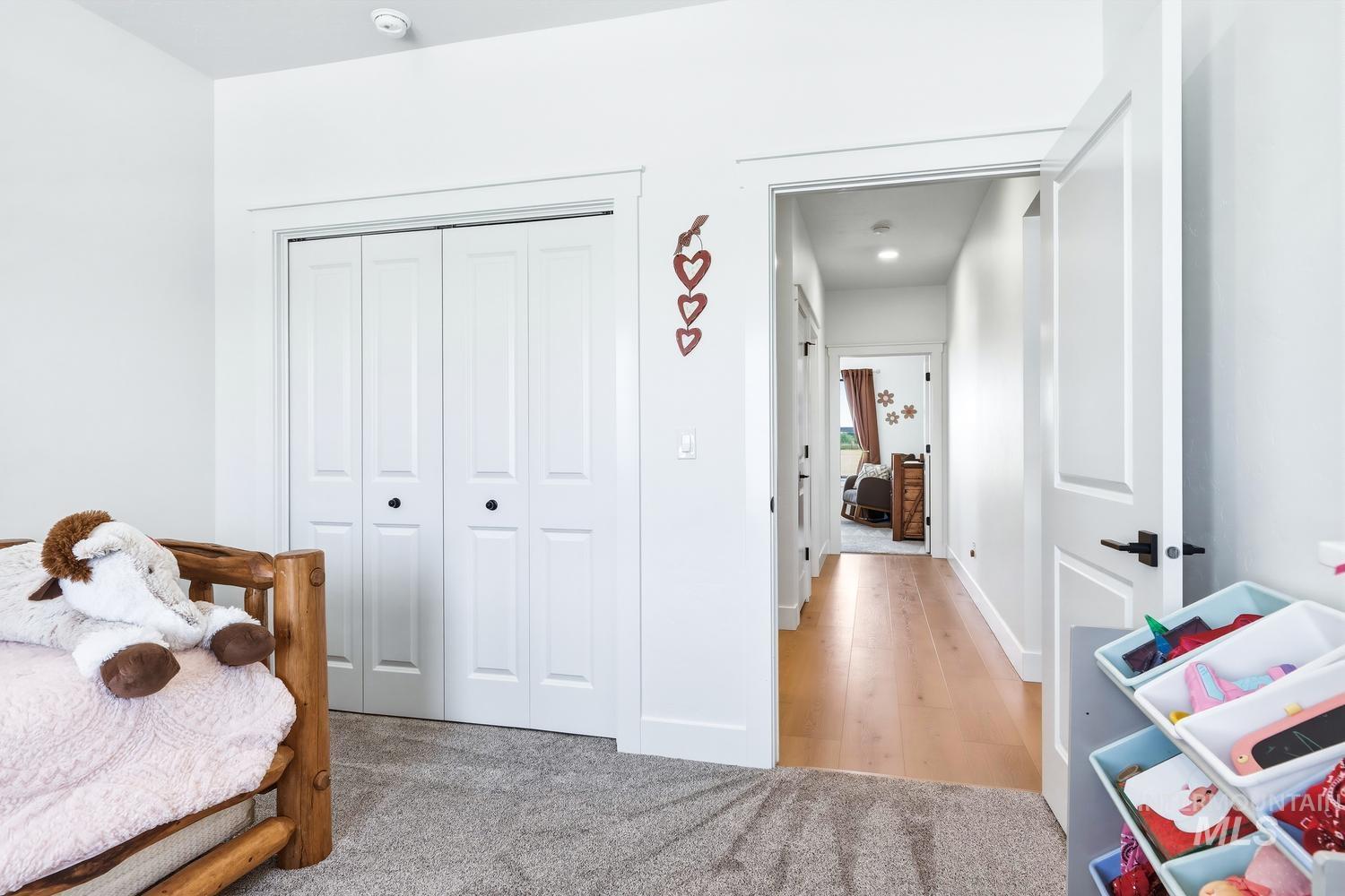 18658 Tranquil Place Caldwell, ID 83607 - Photo 29 of 44 Interior room featuring light gray carpet, white walls, and a white bi-fold closet door with black hardware