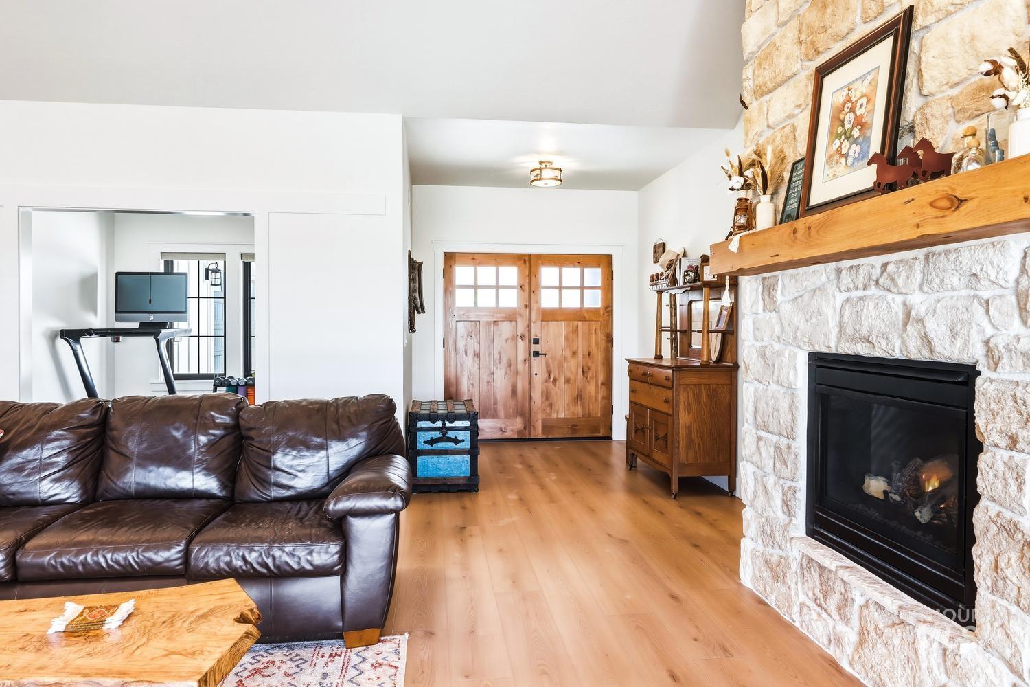 18658 Tranquil Place Caldwell, ID 83607 - Photo 8 of 44 Stone-clad fireplace with a natural wood mantel