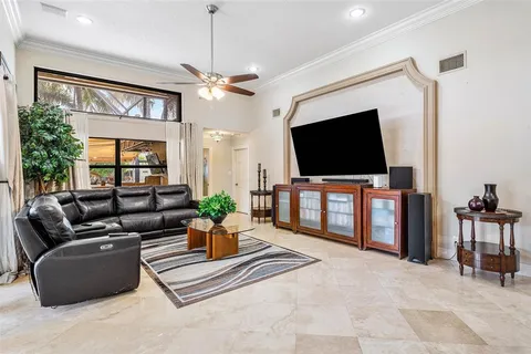 a living room with furniture kitchen view and a large window