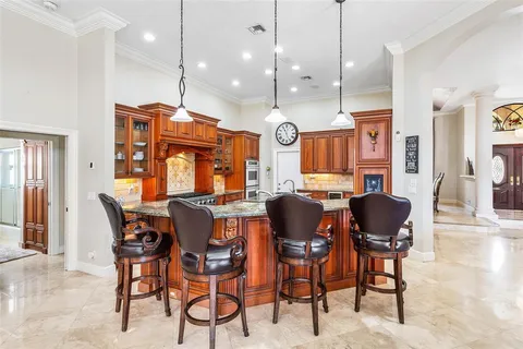 a kitchen with granite countertop a sink and a stove