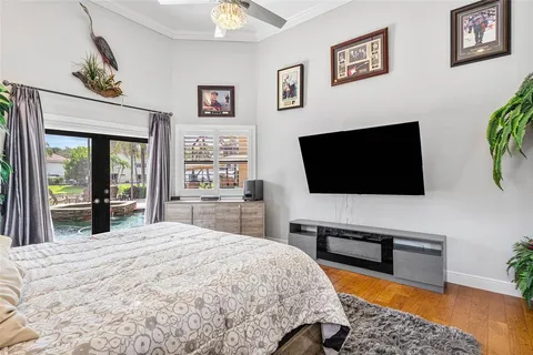 a bedroom with a bed and dresser with mirror