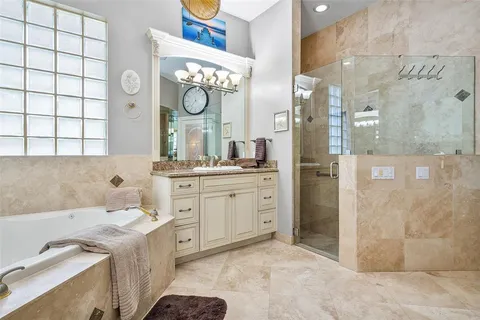 a bed sitting in a spacious bedroom next to a window