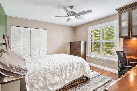 a bathroom with a granite countertop toilet sink and mirror
