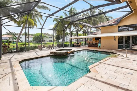 a swimming pool with outdoor seating and yard