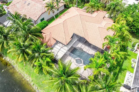 an aerial view of residential house with outdoor space and swimming pool