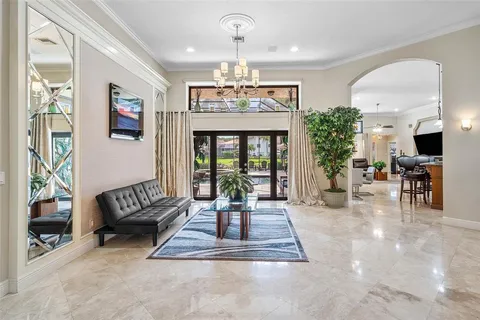 a living room with furniture and a chandelier