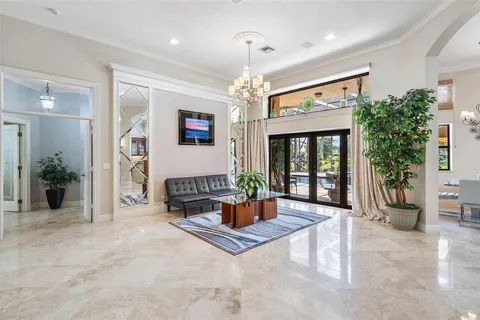 a living room with furniture a chandelier and a fireplace