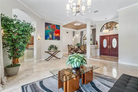 a view of a dining room with furniture and a potted plant