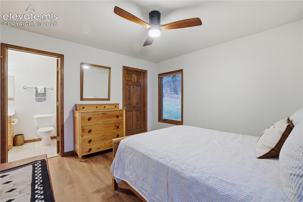 18190 Forest View Road Monument, CO 80132 - Photo 30 of 50 a bedroom with a bed and a dresser