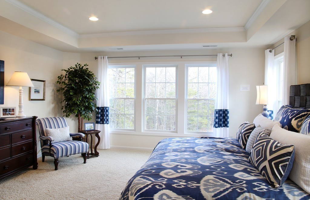 4 Locust Lane, Unit 49 Hopkinton, MA 01748 - Photo 13 of 17 a spacious bedroom with a bed and a couch