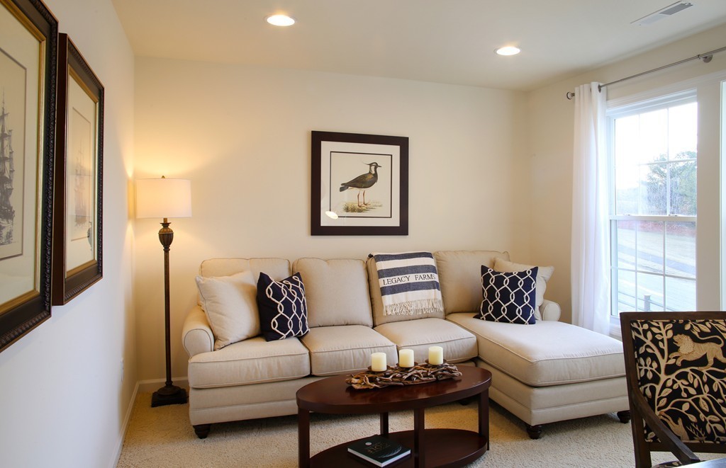 4 Locust Lane, Unit 49 Hopkinton, MA 01748 - Photo 15 of 17 a living room with furniture and a large window