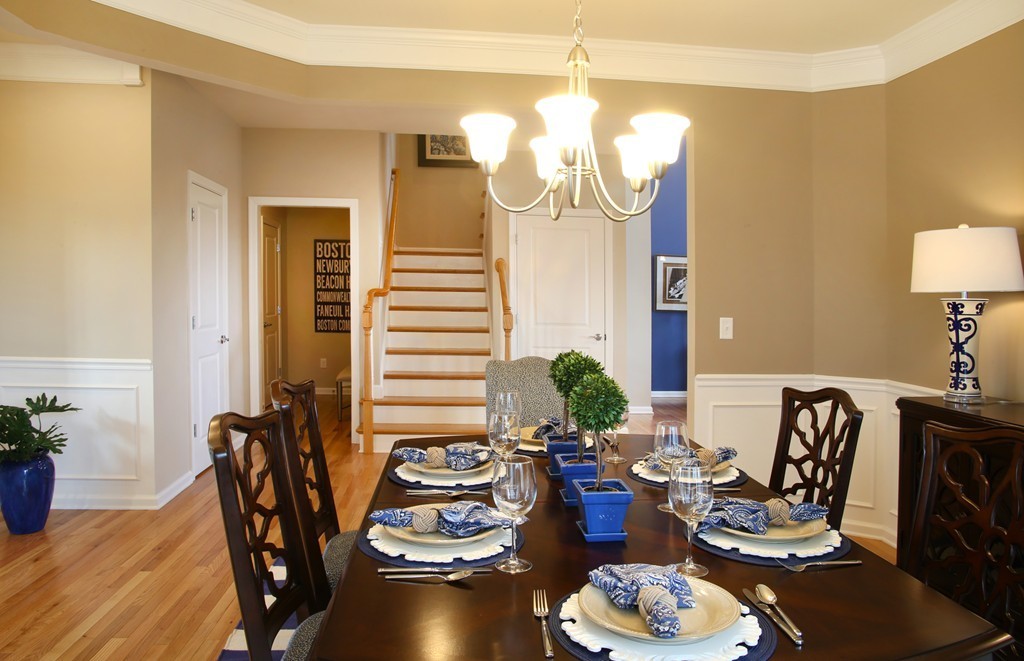 4 Locust Lane, Unit 49 Hopkinton, MA 01748 - Photo 16 of 17 a living room with furniture a chandelier and a dining room