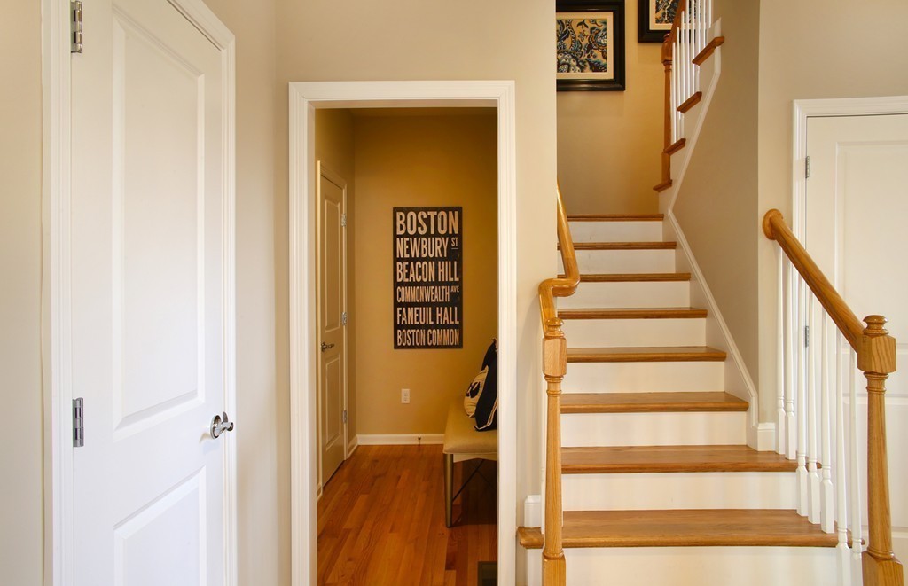 4 Locust Lane, Unit 49 Hopkinton, MA 01748 - Photo 6 of 17 a view of staircase with white walls and a door