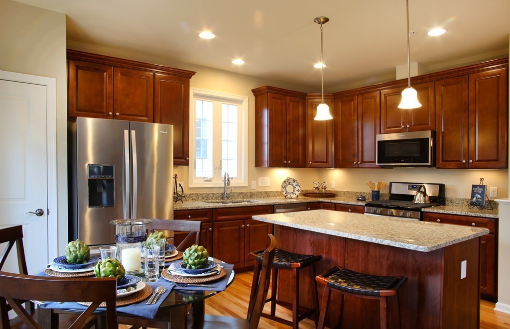 4 Locust Lane, Unit 49 Hopkinton, MA 01748 - Photo 8 of 17 a kitchen with a sink stove and refrigerator
