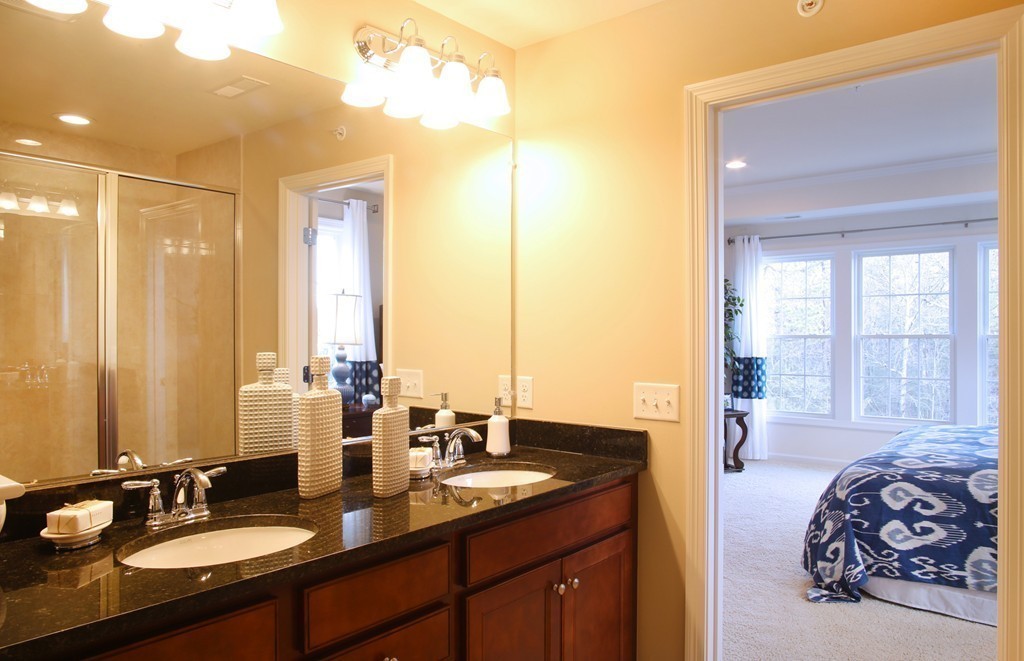 4 Locust Lane, Unit 49 Hopkinton, MA 01748 - Photo 10 of 17 a en suite bathroom with a granite countertop sink and a mirror