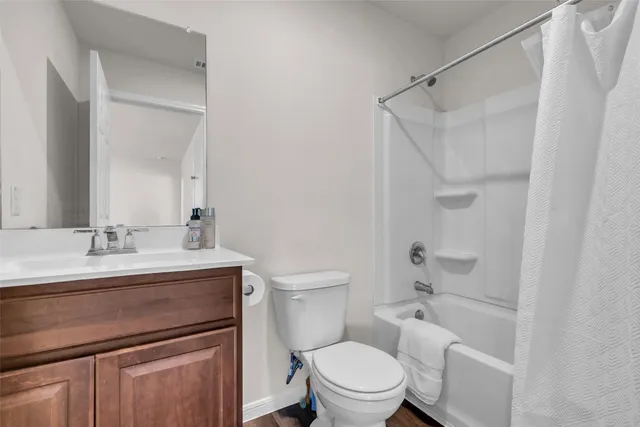 a bathroom with a granite countertop sink toilet a mirror and shower
