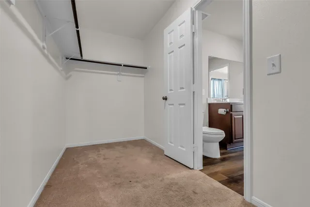 a view of a room with wooden floor and bathroom