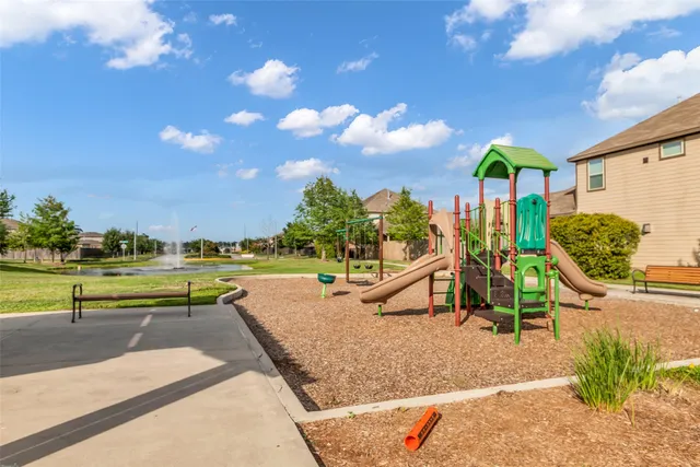 a view of a swimming pool with a patio and a yard