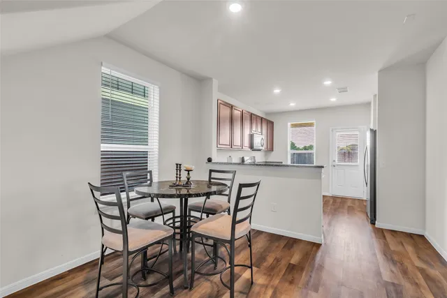 a view of a dining room with furniture and wooden floor