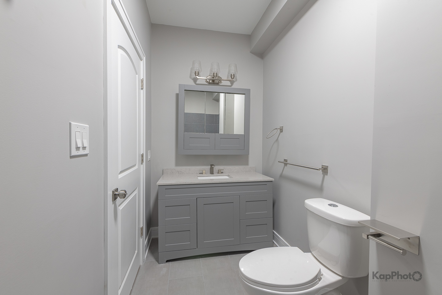 3044 West Irving Park Road, Unit 2 Chicago, IL 60618 - Photo 17 of 27 a bathroom with a granite countertop toilet sink and mirror