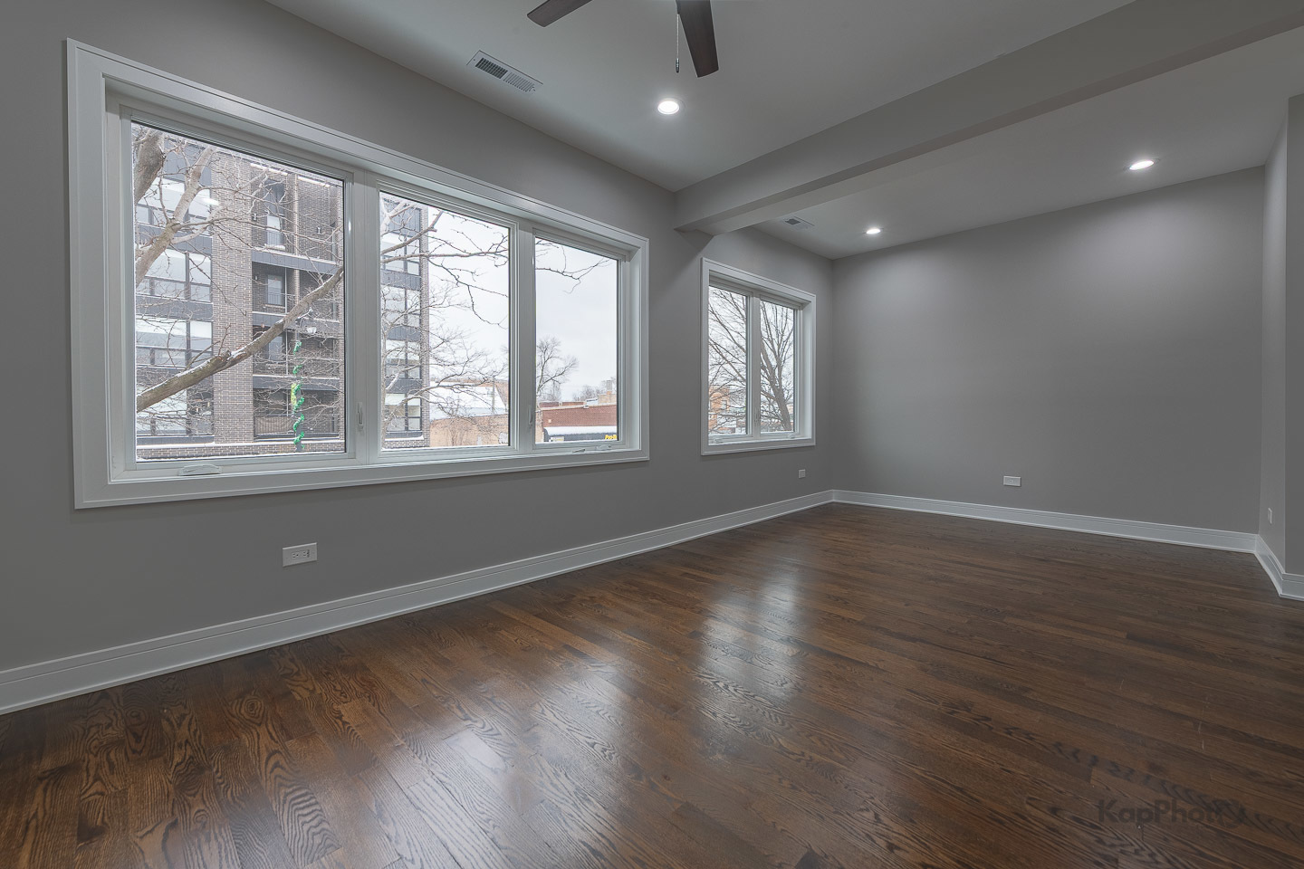 3044 West Irving Park Road, Unit 2 Chicago, IL 60618 - Photo 6 of 27 a view of an empty room with wooden floor and a window
