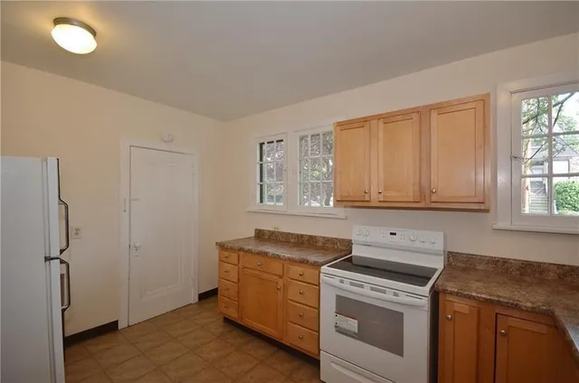 a kitchen with a stove and a refrigerator