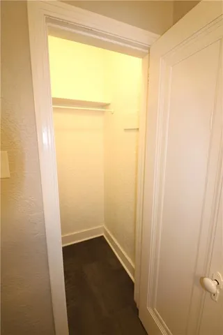 a view of a small space with wooden floor and a window