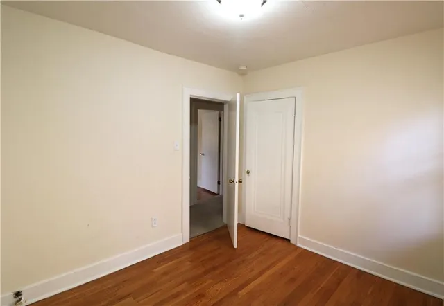 an empty room with wooden floor