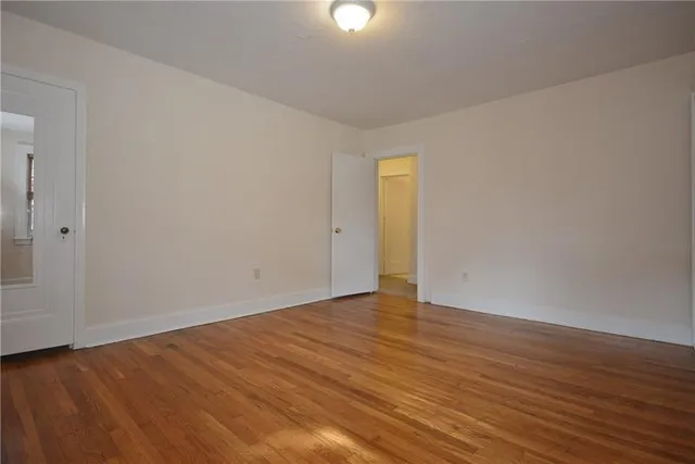 a view of an empty room and wooden floor