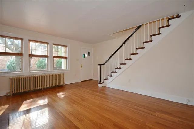 a view of an entryway with wooden floor and stairs