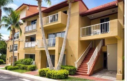 15620 Southwest 80th Street, Unit H304 Miami, FL 33193 - Photo 1 of 8 a front view of a house with a yard