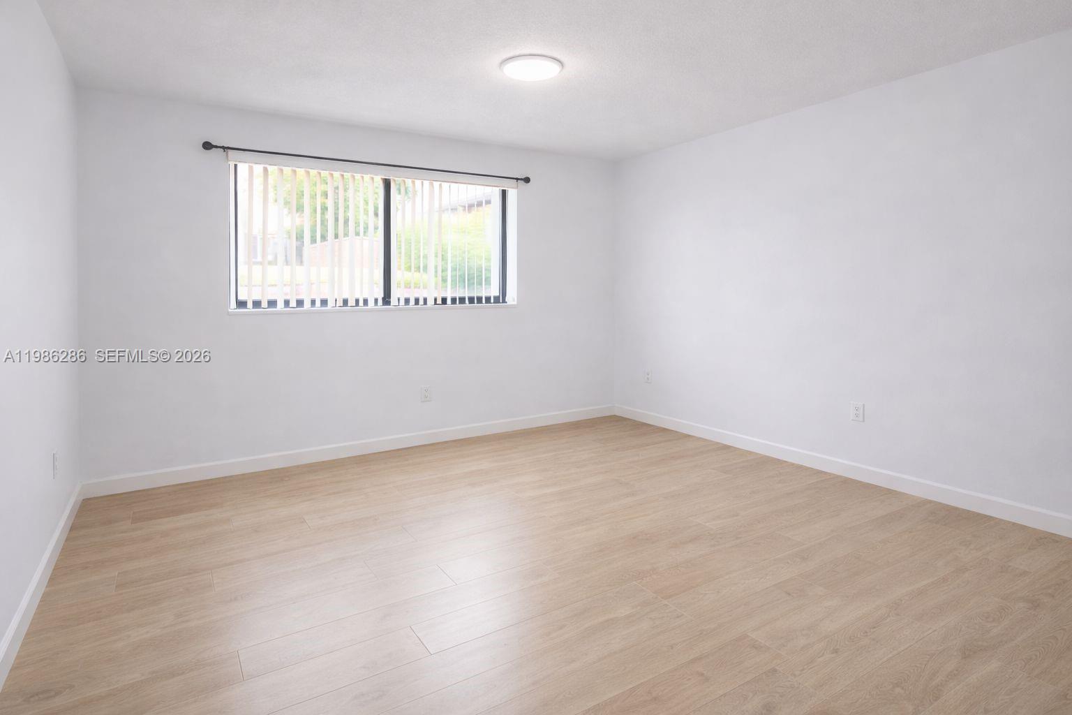 15620 Southwest 80th Street, Unit H304 Miami, FL 33193 - Photo 3 of 8 an empty room with a window