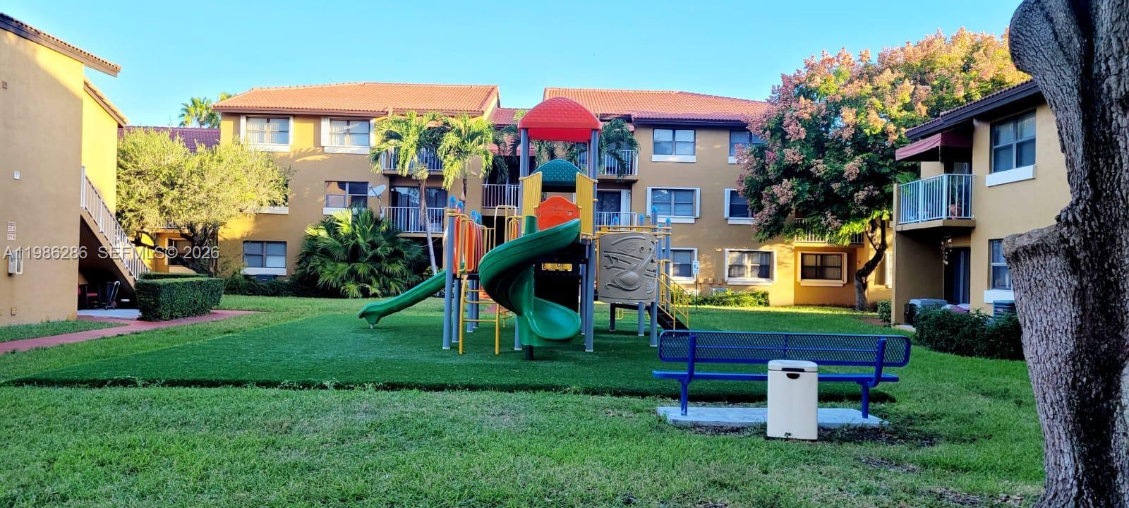 15620 Southwest 80th Street, Unit H304 Miami, FL 33193 - Photo 6 of 8 a front view of a house with a yard