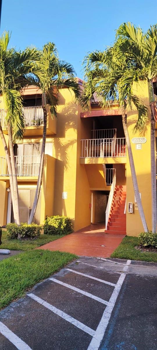 15620 Southwest 80th Street, Unit H304 Miami, FL 33193 - Photo 7 of 8 a front view of a house with a yard