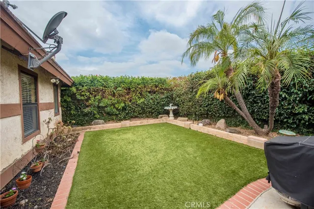 a view of a backyard with plants and a patio