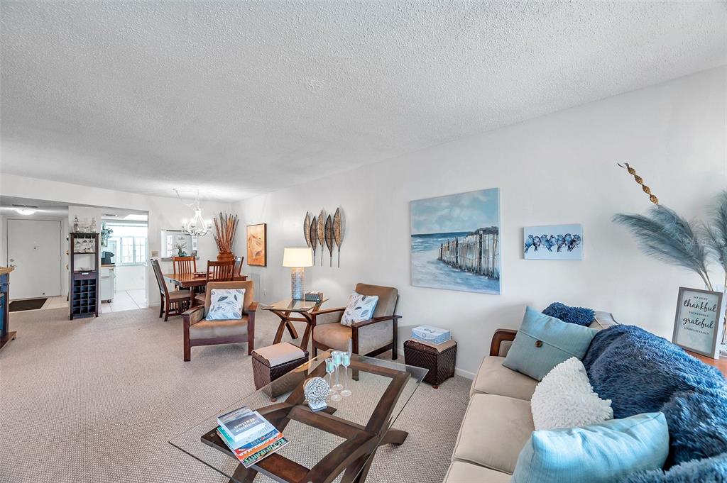 1430 Heather Ridge Boulevard, Unit 304 Dunedin, FL 34698 - Photo 13 of 36 a living room with furniture and a large window